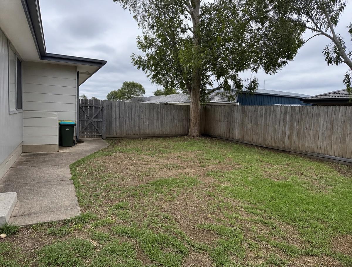 Original suburban backyard before landscaping